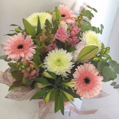 Tender Breeze - A captivating handtied bouquet, delicately arranged with a selection of exquisite flowers. This charming ensemble is presented in a graceful bag, exuding a gentle aura that whisper