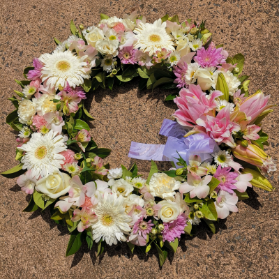 Sweet Memories - Sweet Memories is a tender wreath, adorned in soft pinks and whites, a graceful tribute that embodies the gentle remembrance of a cherished life. With its serene colors, it offers