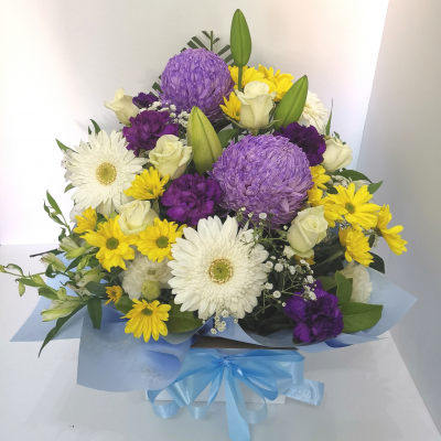 Purple and Yellow - Radiant Harmony is a captivating hand-tied bouquet, artfully blending the regal allure of purple with the vibrant charm of yellow.