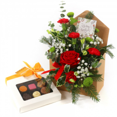 Letter to Santa - Flowers including Chocolates. This is the gift everybody will want this Christmas! The freshest flowers and finest foliage, arranged in a special envelope, delivered with a tasty box of chocolates. 
